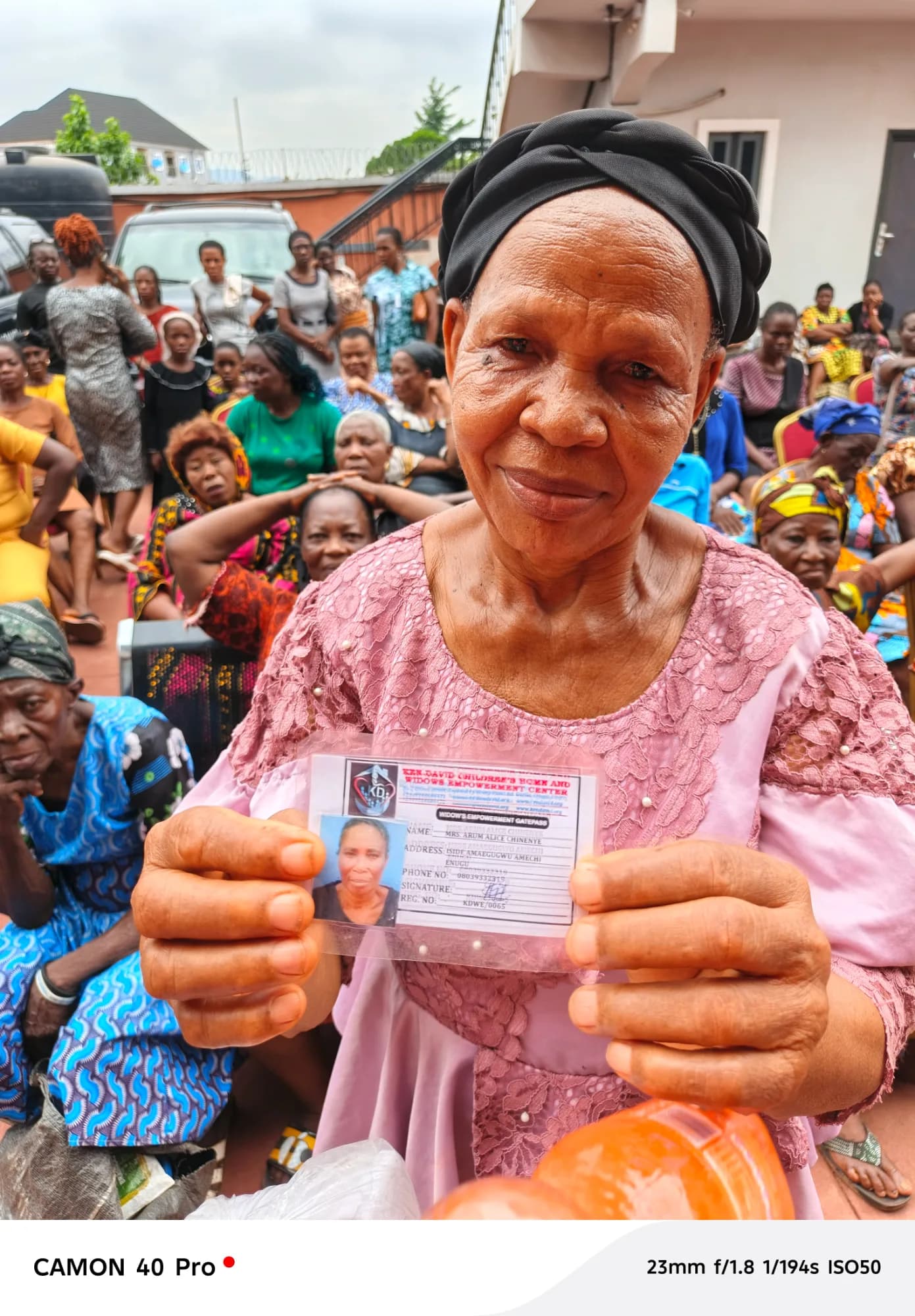 A widow showing her ID card